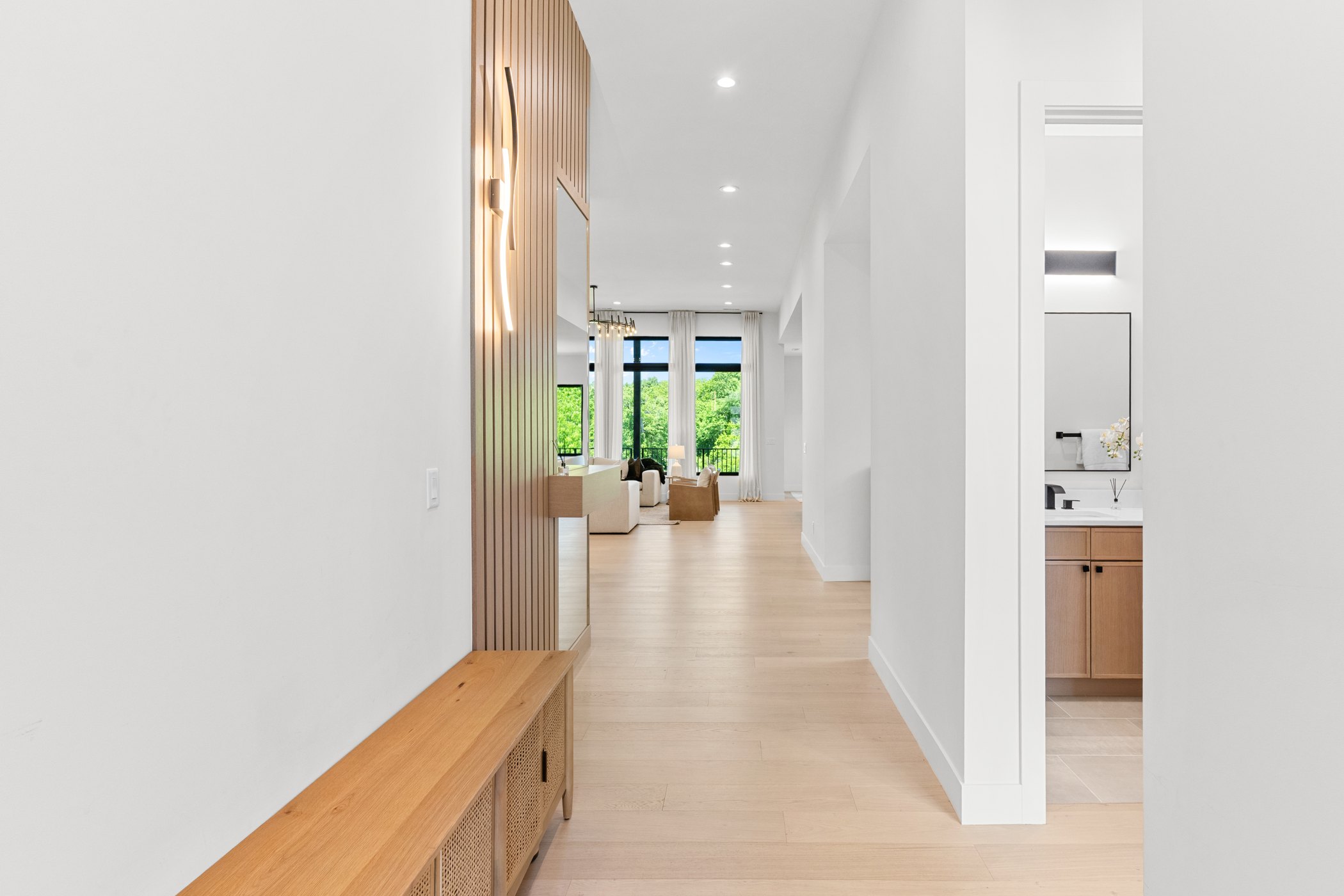 Clean entry hallway showing architectural flow into a luxury living space